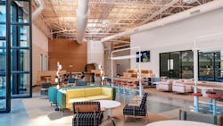 Lounge seating area with pivot doors opening to the exterior. Lounge seating area with pivot doors opening to the exterior.