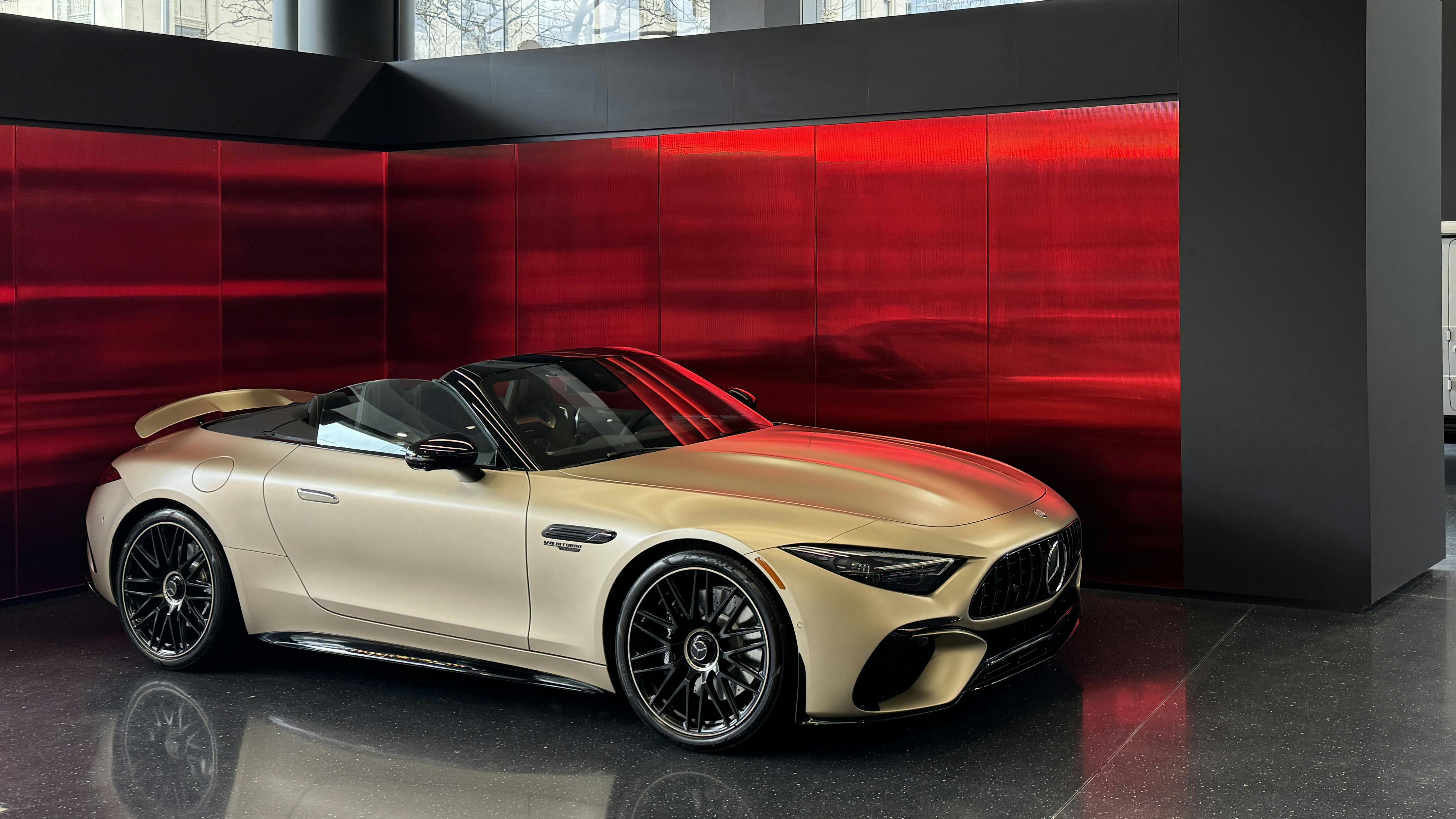 The Mercedes-Benz Showroom in New York, NY, features a fluted red mirror installed with the Z-KISS attachment system. Installation designed and installed by iMBranded