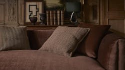 The Antoinette upholstery fabric, shown in Oxblood, is accented by pillows with fabrics Onde Bouclé Brindle in Rosewood and Camelot in Bronzite. The Antoinette upholstery fabric, shown in Oxblood, is accented by pillows with fabrics Onde Bouclé Brindle in Rosewood and Camelot in Bronzite.