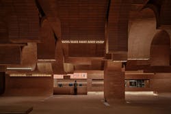 Cinema interior with brick surfaces and filtered daylight, echoing shoreline textures and wave-like patterning. Cinema interior with brick surfaces and filtered daylight, echoing shoreline textures and wave-like patterning.