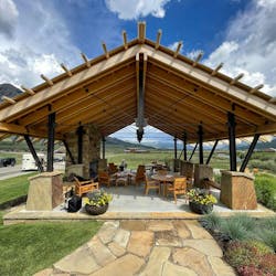 Exposed steel and timber pavilion with stone fireplace shows clear views of mountain, river, and forests. Exposed steel and timber pavilion with stone fireplace shows clear views of mountain, river, and forests.