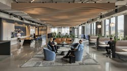 Large, open lounge and cafe are in modern office with lounge seating, area rugs and floor-to-ceiling windows. Large, open lounge and cafe are in modern office with lounge seating, area rugs and floor-to-ceiling windows.