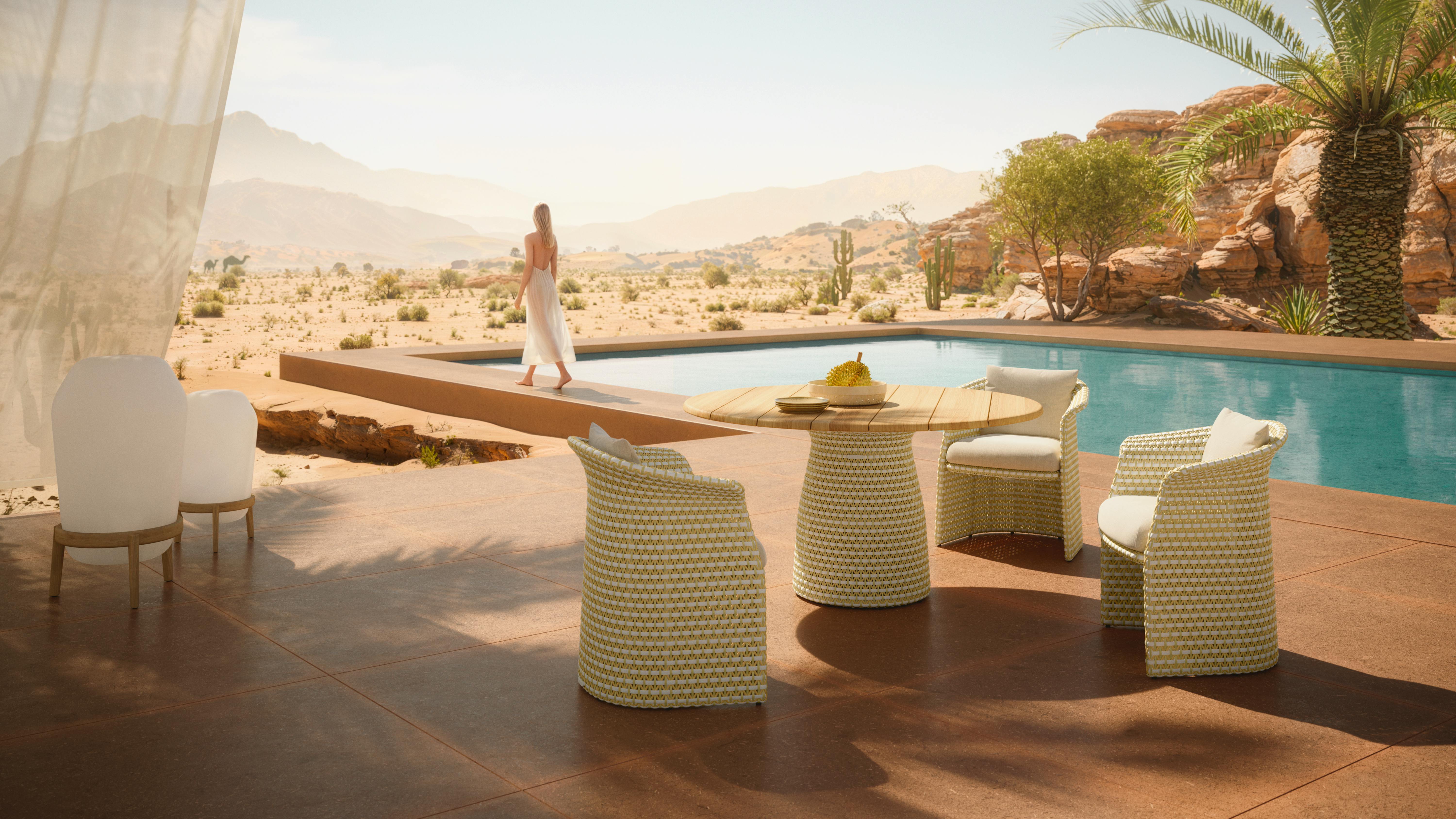 FLLAIR armchairs in yellow create a gathering place near a pool.