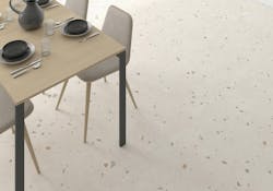 Multicolor speckled tile with a loose terrazzo effect on a dining area floor Multicolor speckled tile with a loose terrazzo effect on a dining area floor