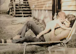 Father holds baby girl outdoors in a lounge chair Father holds baby girl outdoors in a lounge chair