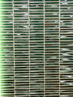 Monopole fools the eye with a large-format glazed green tile that looks like slimmer individual components. Monopole fools the eye with a large-format glazed green tile that looks like slimmer individual components.