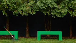 The Vignelli indoor-outdoor collection of benches and tables, showing a bench set in grass. The Vignelli indoor-outdoor collection of benches and tables, showing a bench set in grass.