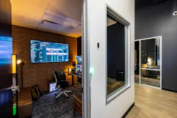 Dude Perfect DPHQ3 interior production office furnished with modular worksurface, ergonomic seating, and multiple computer displays Dude Perfect DPHQ3 interior production office furnished with modular worksurface, ergonomic seating, and multiple computer displays