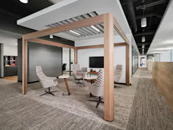 Open collaborative hub designed with acoustic-lined pavilion overhead, extended from interior offices along the central aisle Open collaborative hub designed with acoustic-lined pavilion overhead, extended from interior offices along the central aisle