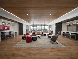 A large social space with layered lighting, daylight access, and multiple seating arrangements from a central lounge setup to counters with task chairs and individual soft seating A large social space with layered lighting, daylight access, and multiple seating arrangements from a central lounge setup to counters with task chairs and individual soft seating