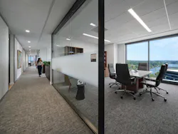Perimeter office with transparent glass walls allows occupants to maintain a connection with the adjacent circulation path. Perimeter office with transparent glass walls allows occupants to maintain a connection with the adjacent circulation path.