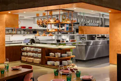 The guest experience connects to a lovely central cooking suite, giving patrons a glimpse into culinary activities without detracting from the elegance of materials and cleverness of spatial sequencing. The guest experience connects to a lovely central cooking suite, giving patrons a glimpse into culinary activities without detracting from the elegance of materials and cleverness of spatial sequencing.