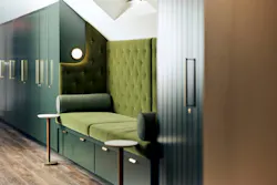 Day spa service area in saturated green hues, with upholstered bench seat between built-in cabinets Day spa service area in saturated green hues, with upholstered bench seat between built-in cabinets