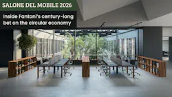An open workspace has wood-look laminate shelves acting as dividers between long worktables with a window to interior courtyard An open workspace has wood-look laminate shelves acting as dividers between long worktables with a window to interior courtyard