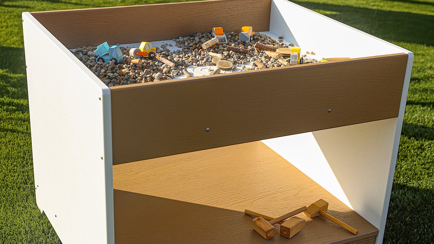 outdoorED Big and Wide Table with rocks and toys inside.