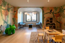 Animal-themed murals decorate the walls in a children's playroom equipped with hardy furnishings and finishes. Animal-themed murals decorate the walls in a children's playroom equipped with hardy furnishings and finishes.