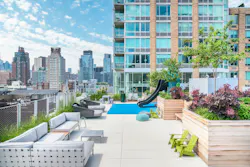 A beautifully appointed outdoor lounge incorporates an adjacent play area so adult residents can relax while keeping sight of their children A beautifully appointed outdoor lounge incorporates an adjacent play area so adult residents can relax while keeping sight of their children