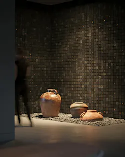 Acoustic wall treatment with grid pattern in a charcoal and deep brown textured stone look with artisan pottery urns in foreground Acoustic wall treatment with grid pattern in a charcoal and deep brown textured stone look with artisan pottery urns in foreground