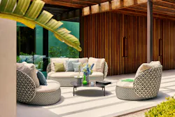 Patio with patterned soft seating, solid color throw pillows, and sleek center table Patio with patterned soft seating, solid color throw pillows, and sleek center table