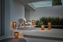 Outdoor lounge space with multiple wood and wicker, rechargeable LED lamps Outdoor lounge space with multiple wood and wicker, rechargeable LED lamps