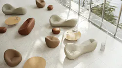 Sculptural, curved soft seating arranged in a commercial lobby space Sculptural, curved soft seating arranged in a commercial lobby space