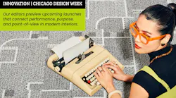 Woman wearing orange framed glasses lays on her stomach on patterned carpeting, while working on a vintage typewriter Woman wearing orange framed glasses lays on her stomach on patterned carpeting, while working on a vintage typewriter
