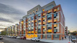 Exterior view of new affordable multifamily project at dusk. Exterior view of new affordable multifamily project at dusk.