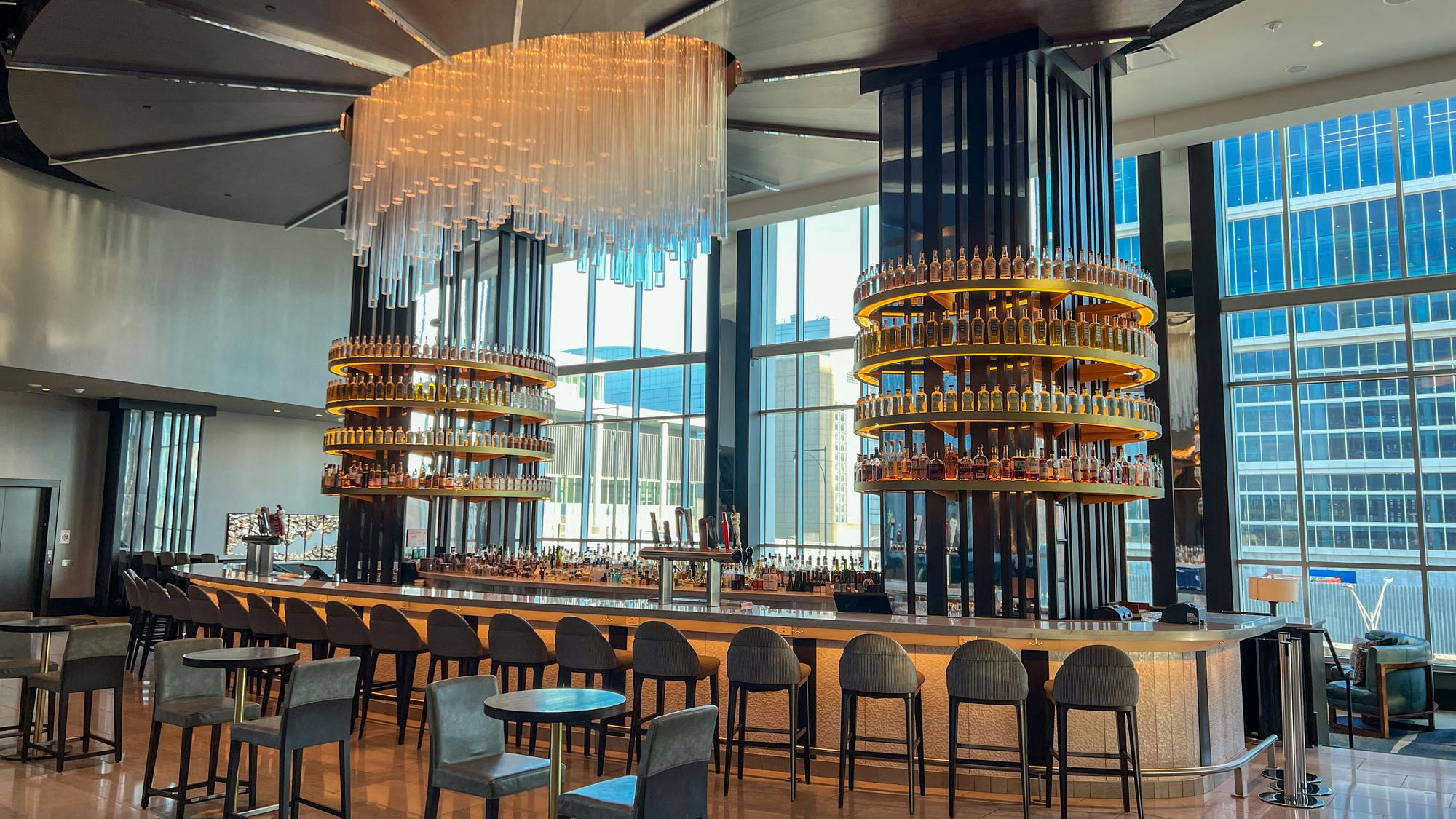 Luxury hotel bar with chandelier and curved bar top