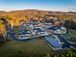 An overhead view shows the neighborhood style layout of Amber Grace Community, with community amenities and residences for supportive living that serve adults with intellectual and developmental disabilities. An overhead view shows the neighborhood style layout of Amber Grace Community, with community amenities and residences for supportive living that serve adults with intellectual and developmental disabilities.