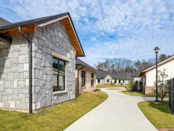 Exterior pathways wind between residences and amenity facilities at Amber Grace Community to encourage walking and social interaction. Exterior pathways wind between residences and amenity facilities at Amber Grace Community to encourage walking and social interaction.