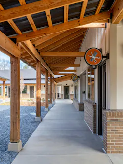 Covered walkways and intuitive signage direct residents around to the community center and village green amenities. Covered walkways and intuitive signage direct residents around to the community center and village green amenities.