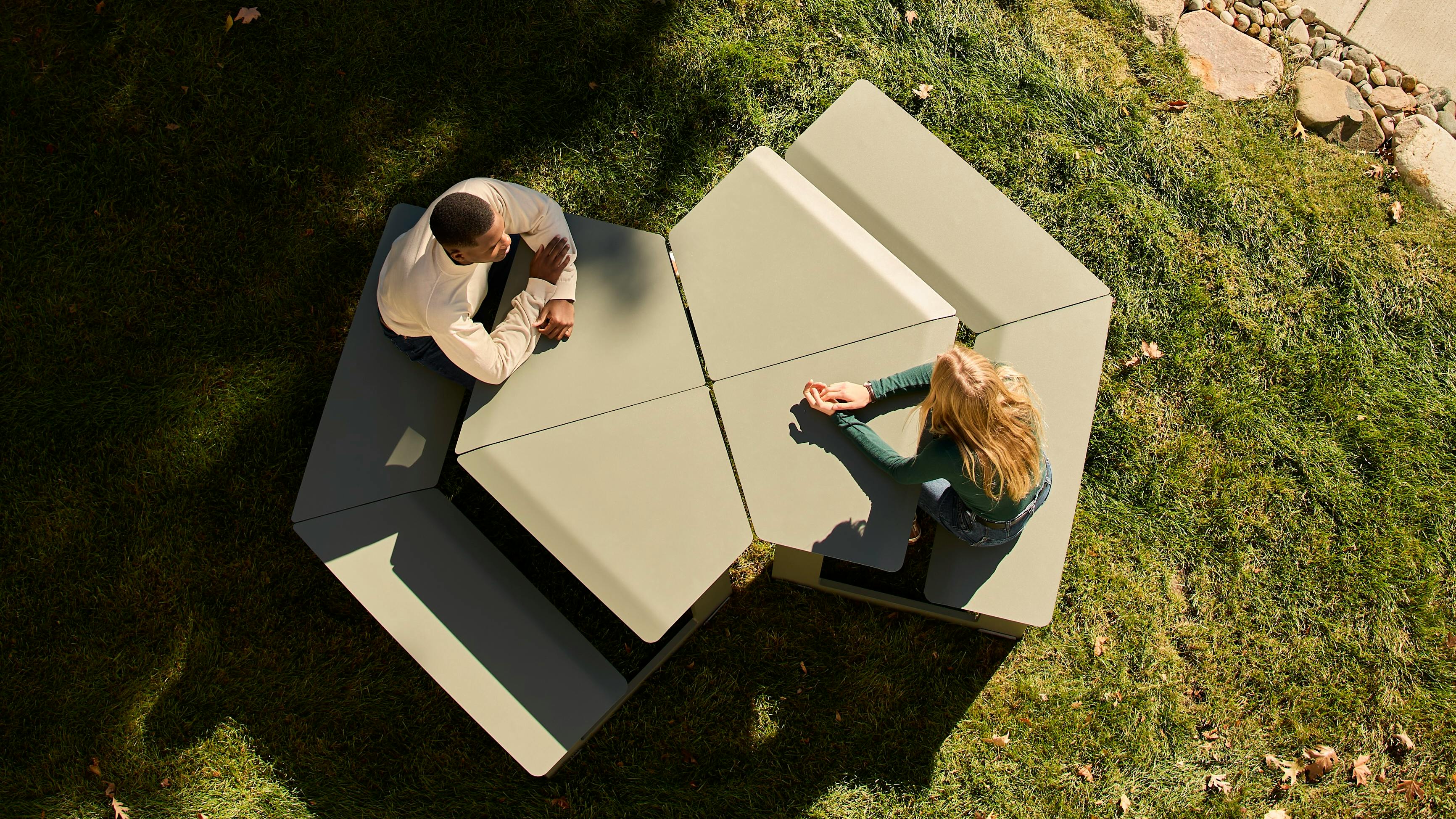 Landscape Forms' Takeout Wedge benches arrange together for gathering collaboration opportunities. Shown with four wedge tables brought together.