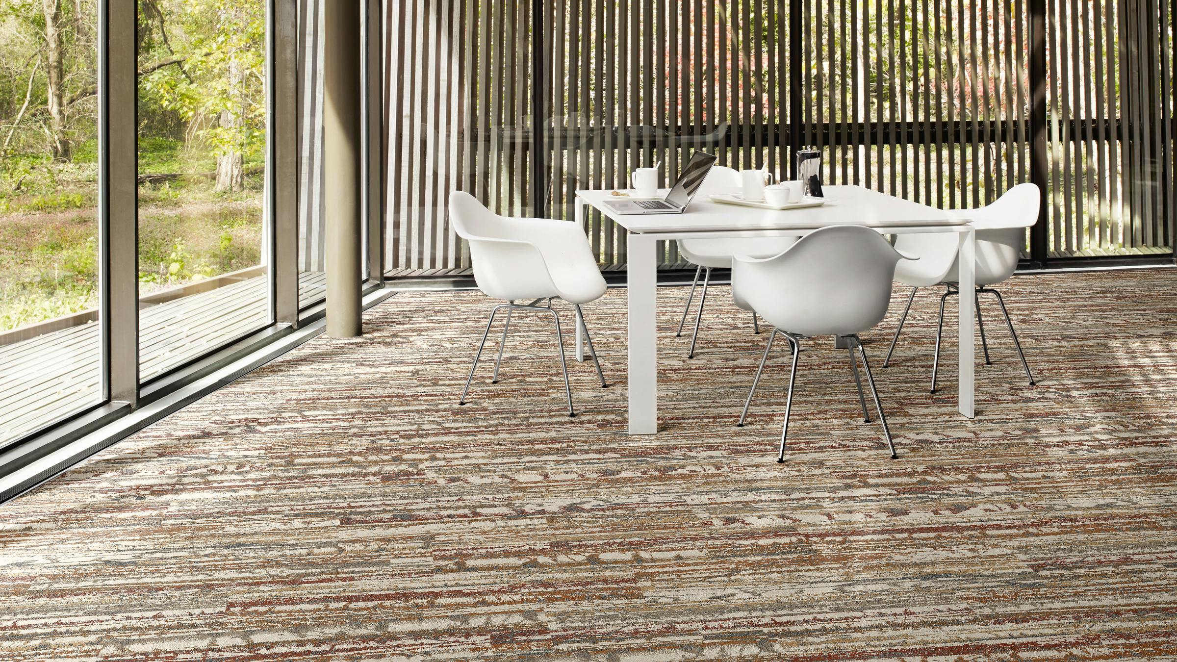 Forest Within carpet tile collection shown in the Shifting Seasons pattern in an Autumn colorway and Ashlar layout.