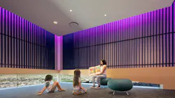 The library's story room creates an intimate setting where soft light and warm materials support focus, imagination, and shared storytelling.