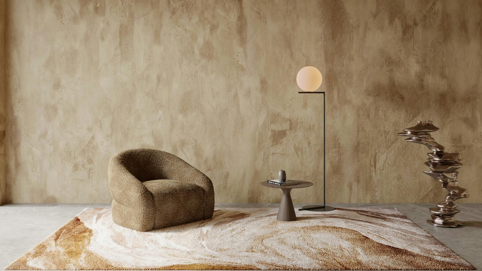 STEPEVI Caresse Collection shown in the desert colorway. A chair, side table and lamp are set up on the rug.
