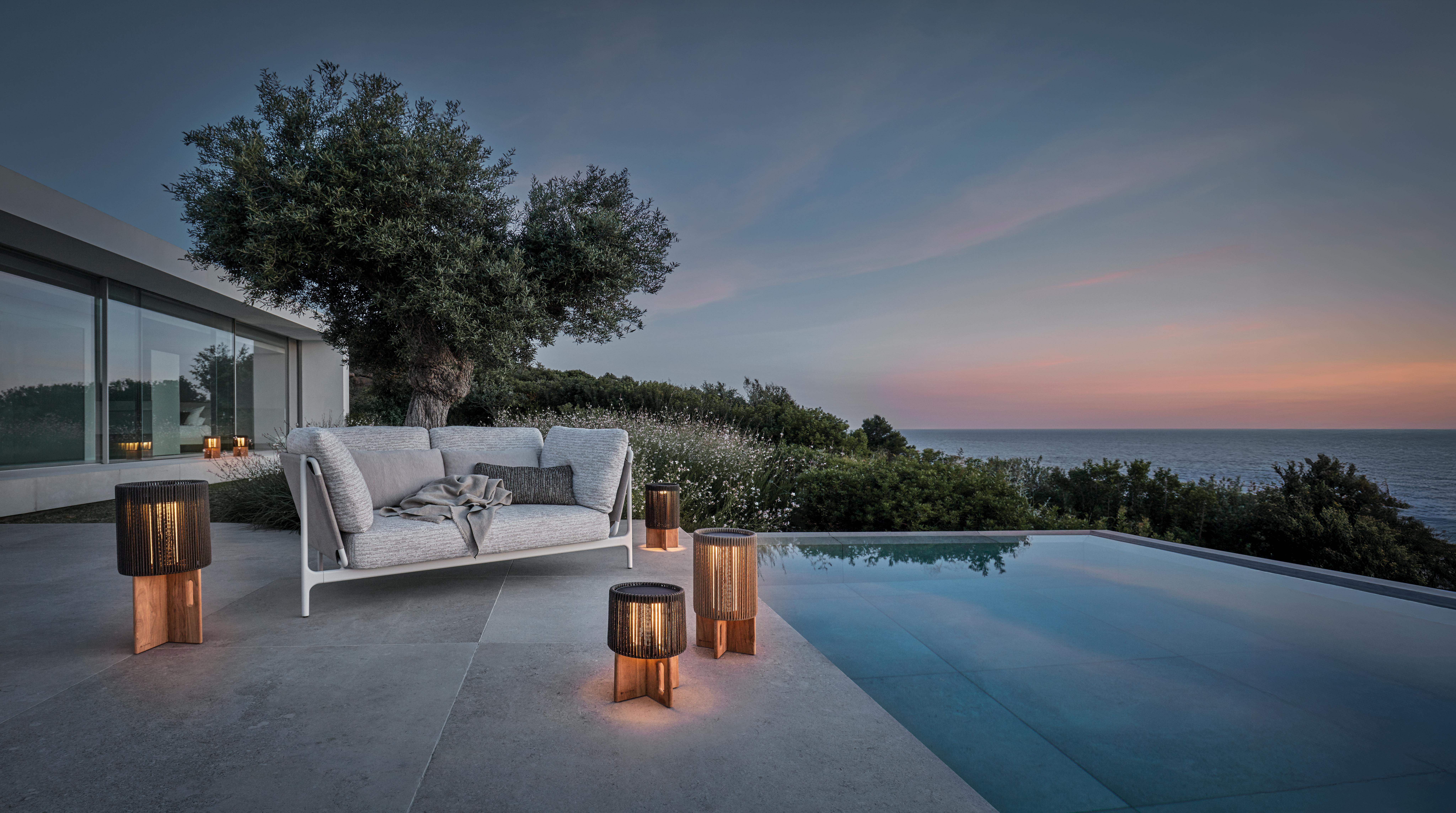 AMBIENT Compass lights set up poolside at sunset.
