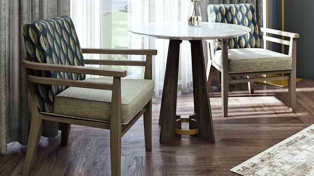 The Meadowbrook armchair shown in the low back option displayed with a table.