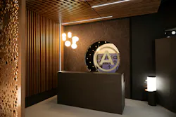 Zone 8 culminates in the Grand Bar area, exuding quiet luxury with a mix of seamlessly integrated illumination, wood wall and ceiling features, marble-look acoustic surfaces, and a custom bar countertop that show depth for hospitality designs.
