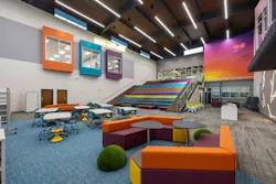The library exemplifies the vivid color palette, such as the sunset mural, assembly stairs, and flexible furniture
