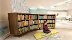 The “Beaver Den” quiet corner is subtly and partially separated from the collaborative area by low, curved storage shelves that provide access to books and classroom materials.
