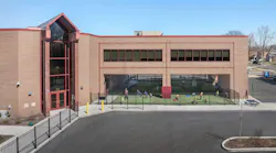 Exterior angled view of Barbara Vick Western Branch school, a multi-story early education center with an outdoor fenced play yard