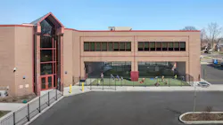 Exterior angled view of Barbara Vick Western Branch school, a multi-story early education center with an outdoor fenced play yard
