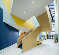 A sculptural stairway becomes a focal point and dynamic gathering space for young learners.