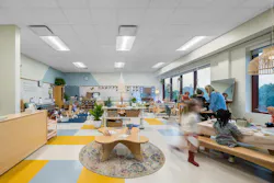 Classroom with large windows features multiple activity zones