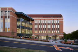 Large education building with glass and brick facade and University of Tennessee branding on the driveway
