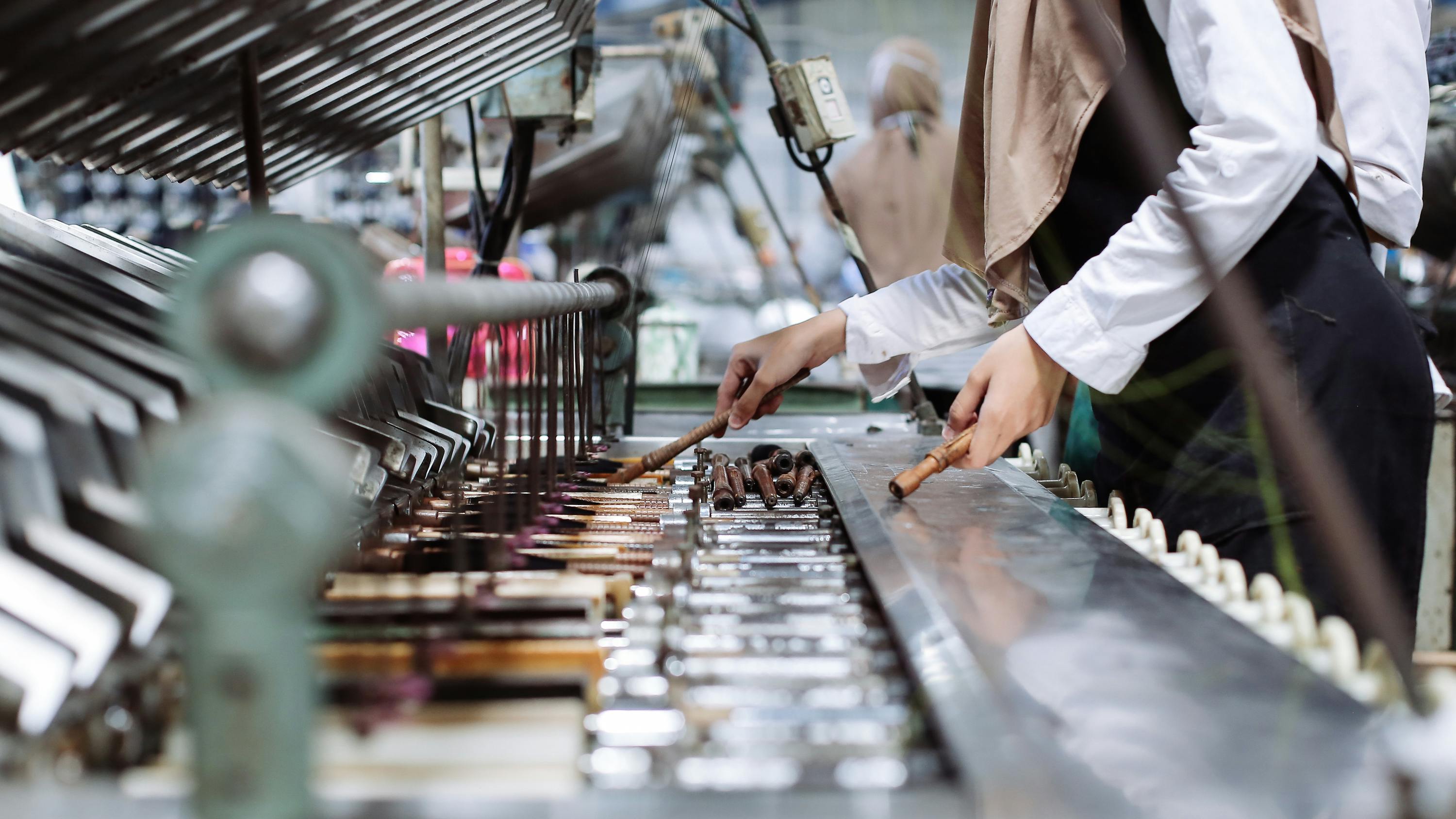 Female workers arranging thread in a textile factory