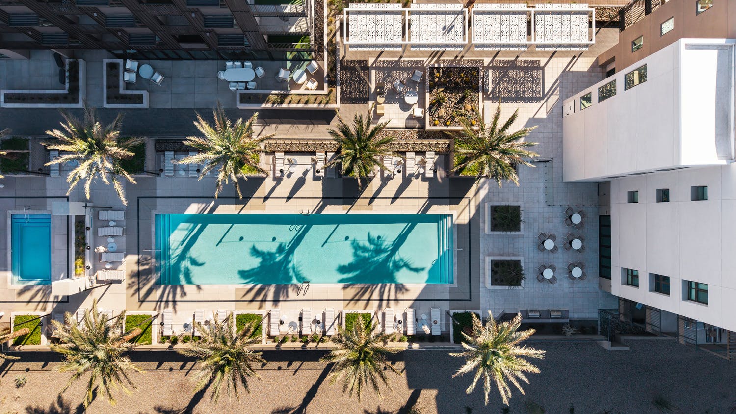 Aerial view of planned multiresidential community with pool and outdoor leisure spaces