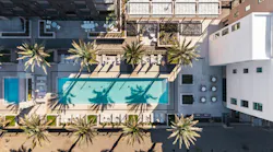 Aerial view of planned multiresidential community with pool and outdoor leisure spaces