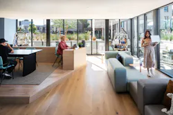Co-working lounger features a variety of seating and workstation options, with hanging basket chairs, task chairs, tabletops, and upholstered bench seating