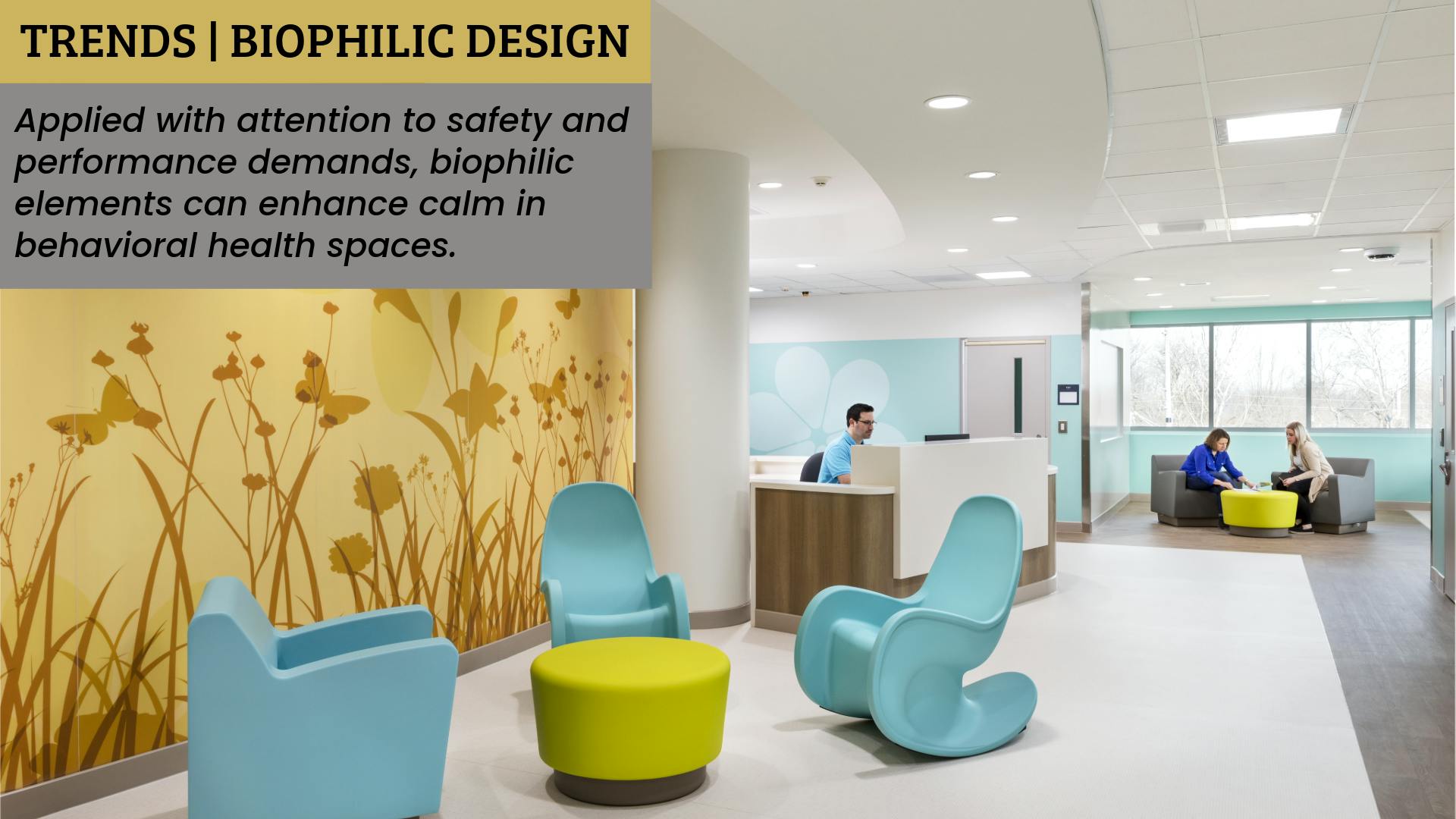 Patient reception and visiting area in a pediatric unit contains soft furnishings with rounded edges and a silhouetted meadow scene printed onto wall protection